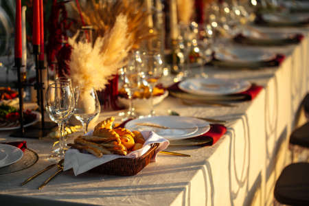 Luxury festive served table outdoor banquet catering with candles glasses