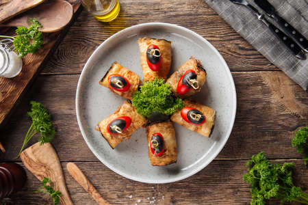 Top view on eggplant rolls appetizer on the wooden tableの写真素材