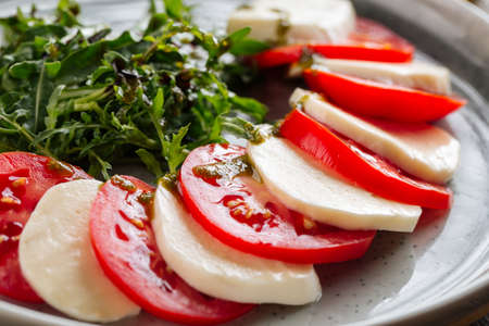 Closeup on classic italian caprese salad on the wooden table