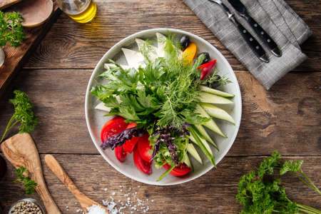Top view on fresh vegetables platter appetizer on the wooden tableの写真素材