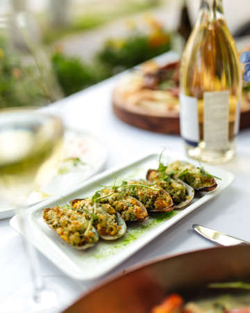 Closeup on appetizing mussels with filling on the white served table