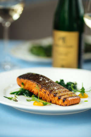Closeup on grilled salmon fillet steak on the blue table