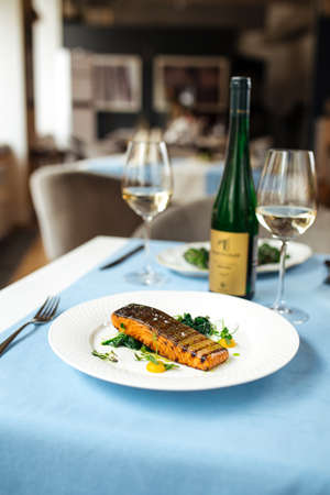 Grilled salmon fillet steak on the served blue table
