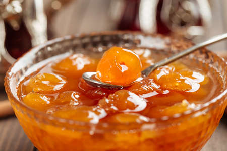 Closeup on white cherry jam in a glass bowl with spoonの写真素材