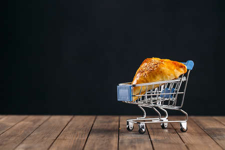 Oriental dish baked pie with meat triangle samsa in miniature trolleyの写真素材