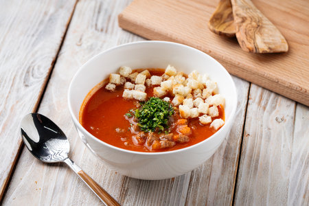 Side view on tomato soup with crackers in a bowlの写真素材