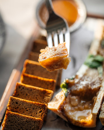 Eating bone marrow with sauce and rye breadの写真素材