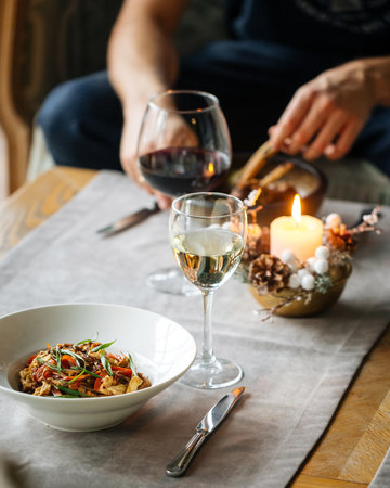 Man dining with gourmet dishes sitting on the sofaの写真素材