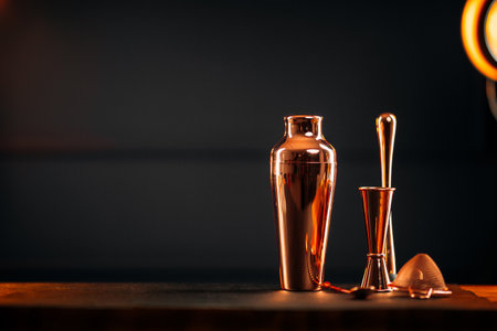 Copper bar tools set with shaker on wooden tableの写真素材