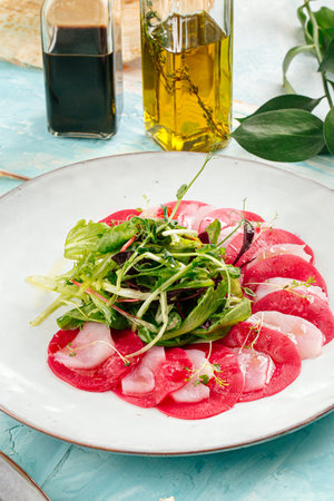 Gourmet appetizer beet root carpaccio with greensの写真素材