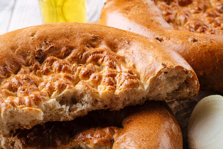 Closeup on broken fresh baked onion flat bread