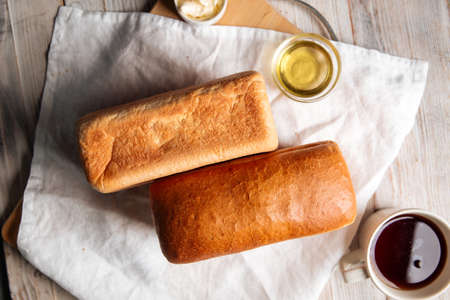 Loafs of white brick shaped bread with butter