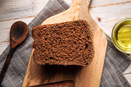 Cut out rye bread on the wooden cutting boardの写真素材