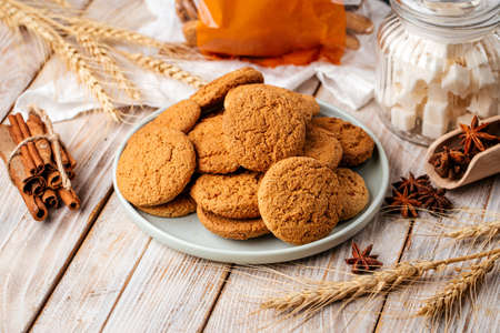 Pile of spicy oatmeal cookies on wooden backgroundの写真素材