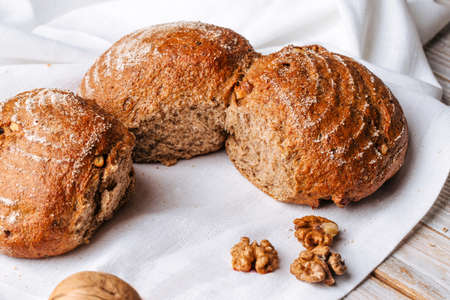 Closeup on rye walnut bread on the wooden tableの写真素材