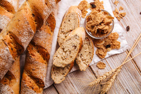 Cereal baguette loafs on the wooden backgroundの写真素材