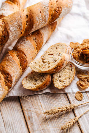 Cereal baguette loafs on the wooden backgroundの写真素材