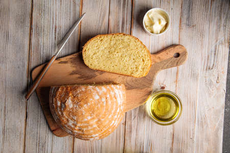 Cut loaf of olive oil bread on the wooden table