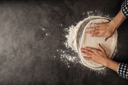 Hands making a pizza dough with flourの写真素材