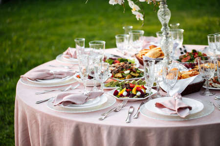 Outdoors nature banquet table set with candlesの写真素材