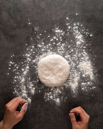 Hands making a pizza dough with flourの写真素材