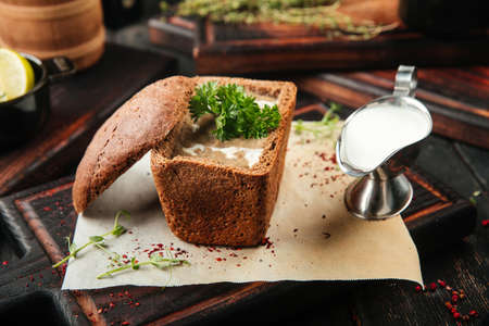Gourmet mushroom cream soup in a bread with sauceの写真素材