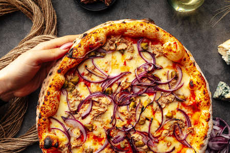 Tuna and capers pizza on the decorated backgroundの写真素材