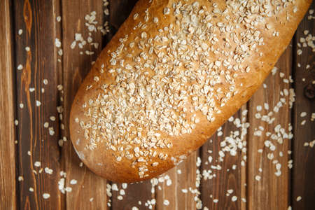 Closeup on fresh baked loaf of bread with oats