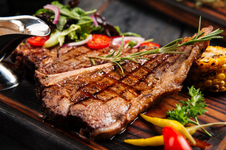 Grilled beef steak with vegetables and sauceの写真素材