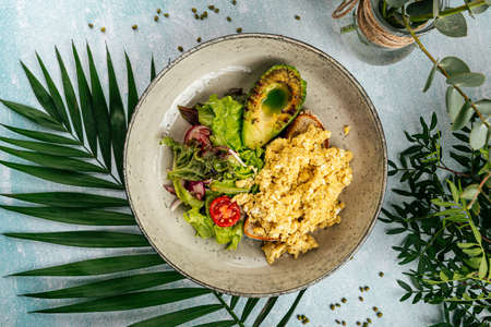 Scramble toast with grilled avocado and saladの写真素材