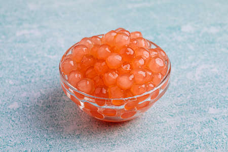 Glass bowl of orange tapioca pearl bubbles