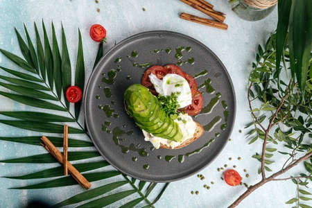 Avocado sandwich with tomato and poached eggの写真素材