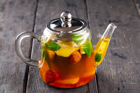 Teapot of herbal fruit tea with strawberryの写真素材