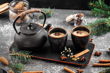 Cast-iron teapot and cups on decorated backgroundの写真素材