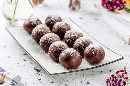Plate of sweet chocolate balls with coconut