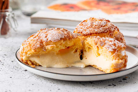 Fresh baked choux pastry cakes with cream