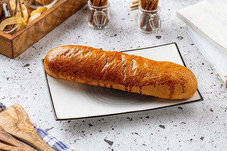 Baked long bun pastry on served table