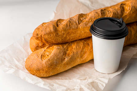 Fresh french baguettes with a cup of coffeeの写真素材
