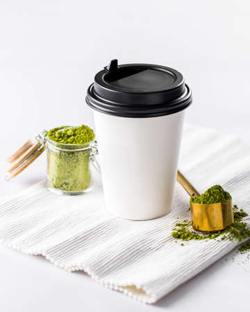 Take away cup of matcha tea on white background