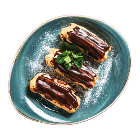 Isolated plate of custard eclairs with chocolate