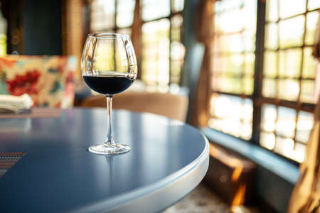 Glass of red wine on the restaurant tableの写真素材