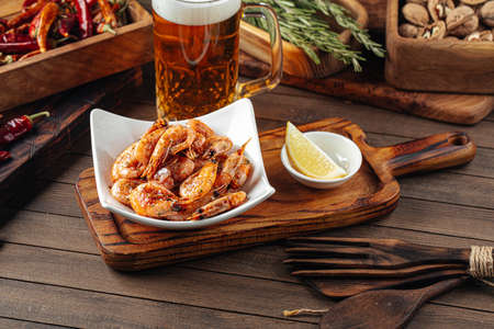 Roasted garlic shrimp appetizer with beerの写真素材