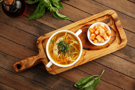 Chicken noodle soup with croutonsの写真素材