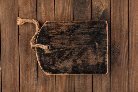 Old dark brown wooden cutting board