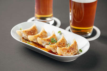 Closeup on japanese gedza dumplings with beer