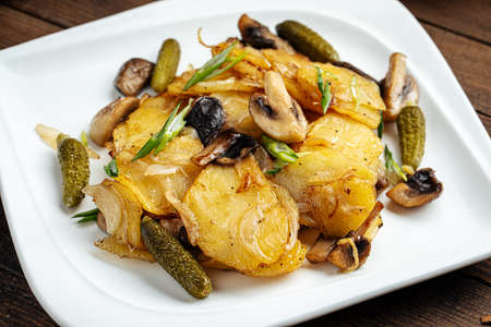 Roasted potatoes with mushrooms and picklesの写真素材