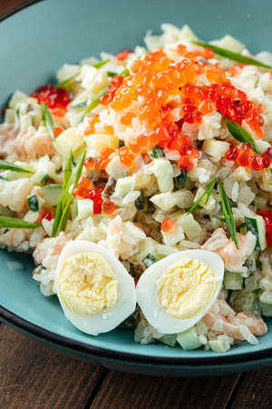 Russian olivier salad with salmon and caviarの写真素材