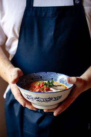 Chef holding bowl of japanese curry chicken ramenの写真素材