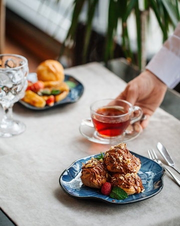 Table served with pastry desserts and teaの写真素材