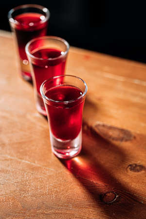 Various shot drinks on the wooden bar deskの写真素材